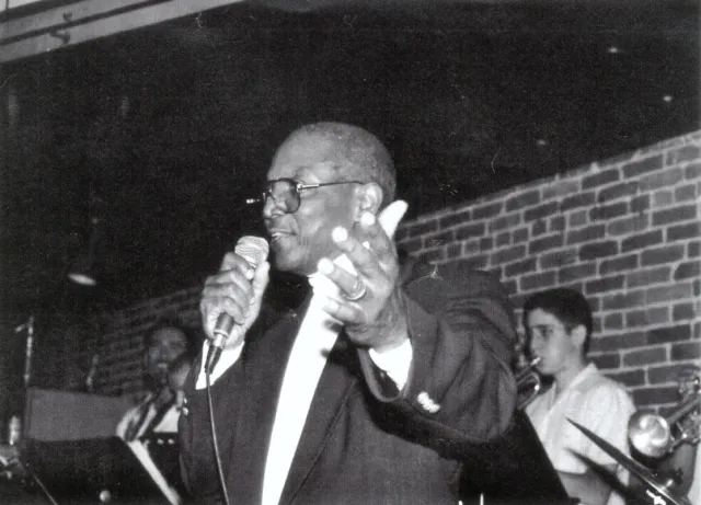 At the mic, greeting his audience