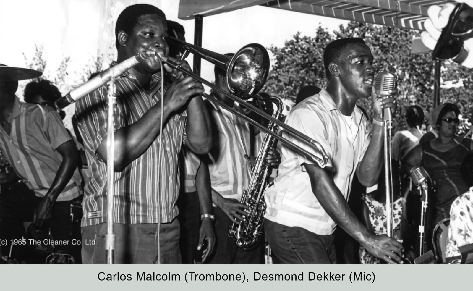 Carlos Malcolm and Desmond Dekker on stage, 1965